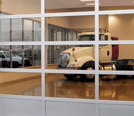 A truck is parked in the garage of a dealership.