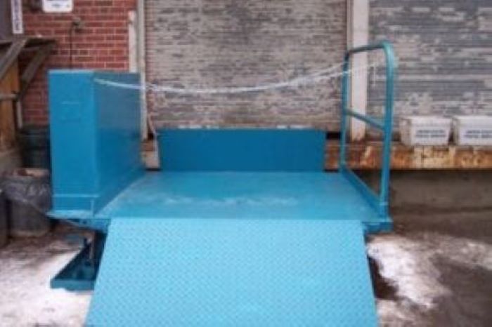 A blue ramp is in the snow outside.